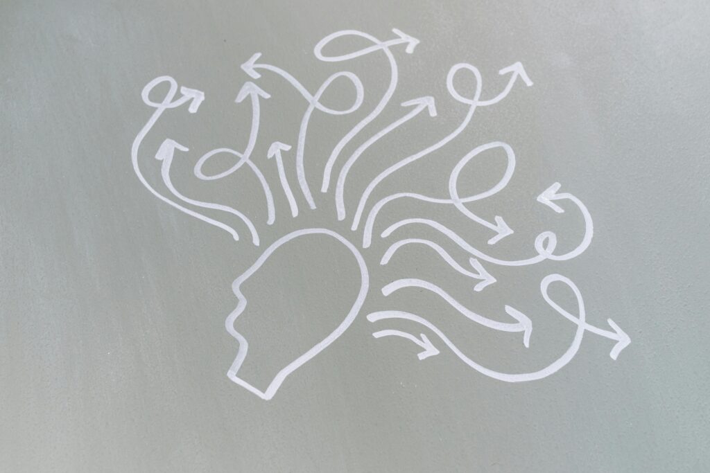 Artist's depiction of thoughts going in different directions out of a person's head. A visual metaphor for executive functioning.